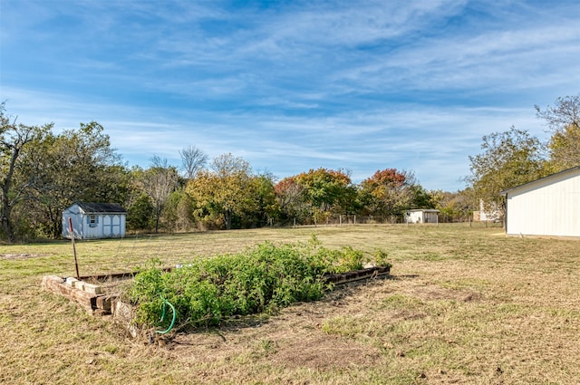 view of yard with a rural view and a storage unit