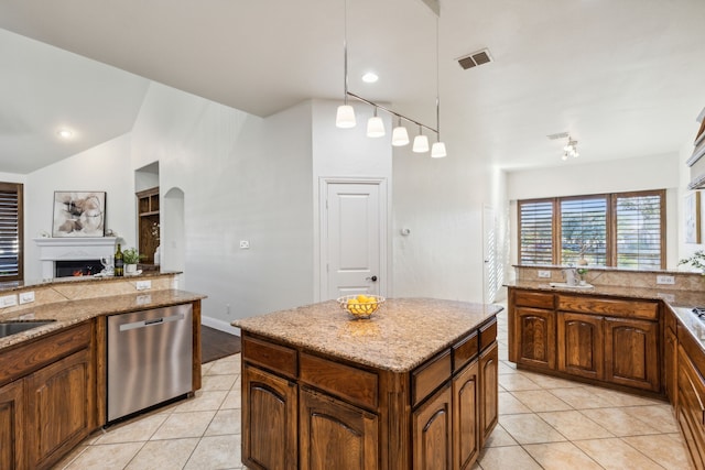 kitchen featuring dishwasher, light tile patterned flooring, pendant lighting, and vaulted ceiling