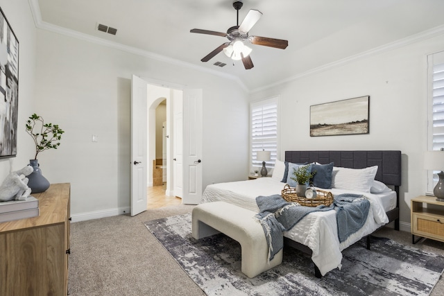 carpeted bedroom featuring ceiling fan and crown molding