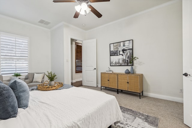 bedroom featuring carpet floors, ceiling fan, and crown molding