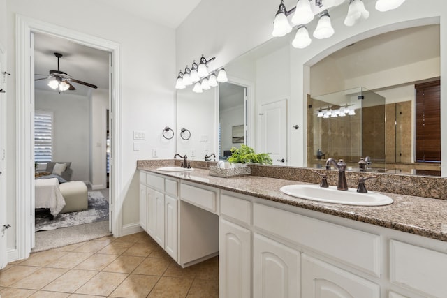 bathroom with tile patterned floors, ceiling fan, vanity, and walk in shower