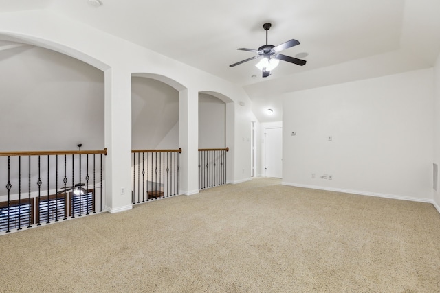 carpeted spare room with ceiling fan