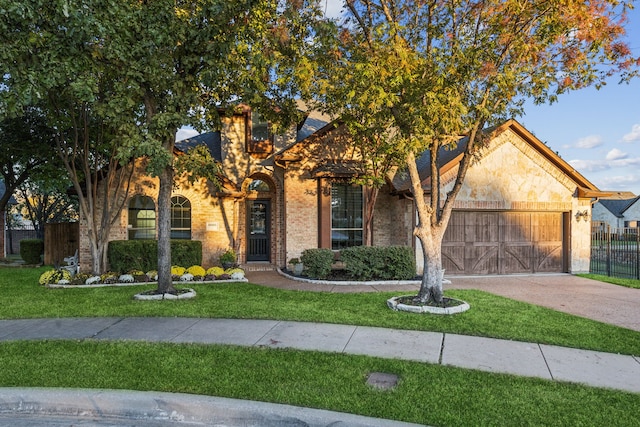 view of front of home with a front yard and a garage