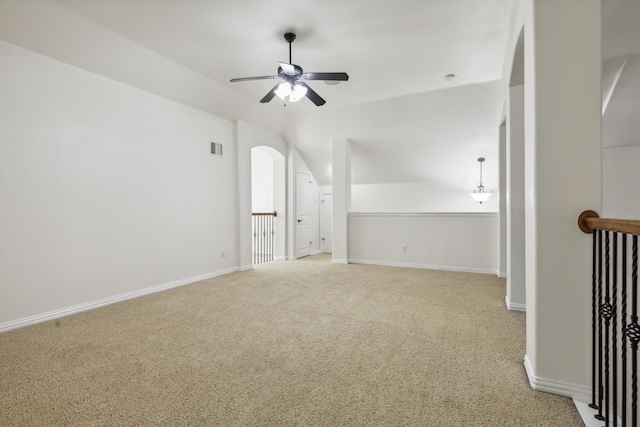 carpeted empty room with ceiling fan and vaulted ceiling