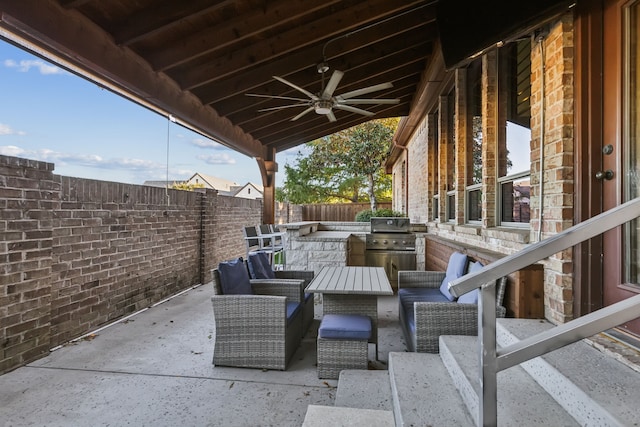 view of patio / terrace with grilling area, ceiling fan, and an outdoor kitchen