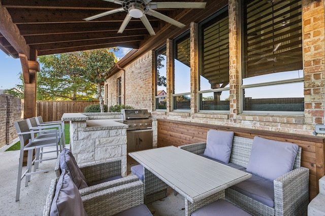 view of patio / terrace with ceiling fan, exterior kitchen, and grilling area