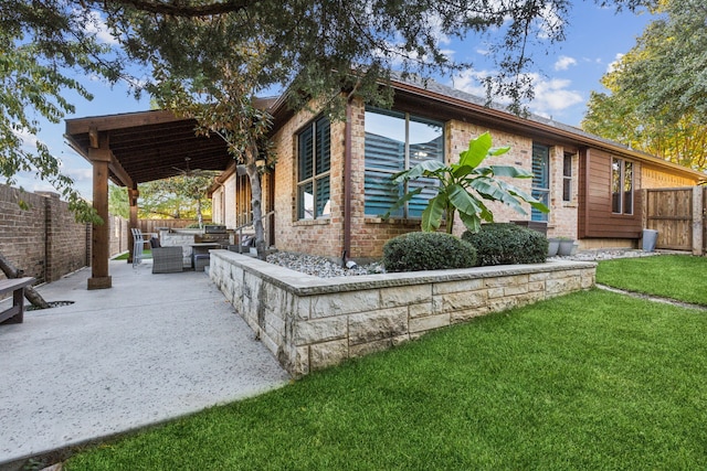 exterior space with outdoor lounge area, a patio area, and a front lawn