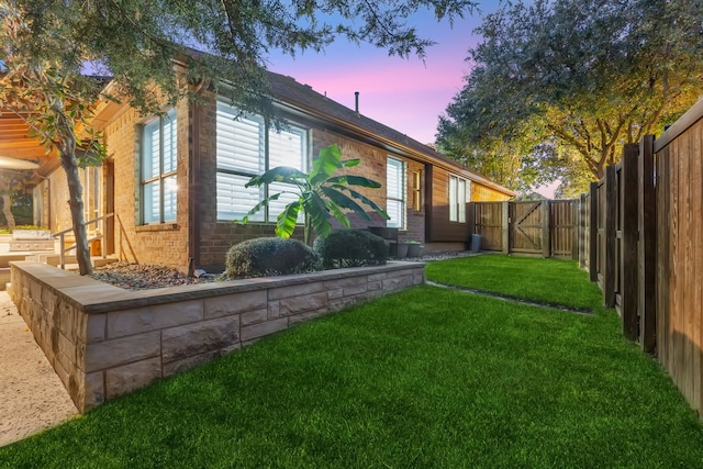 property exterior at dusk with a yard