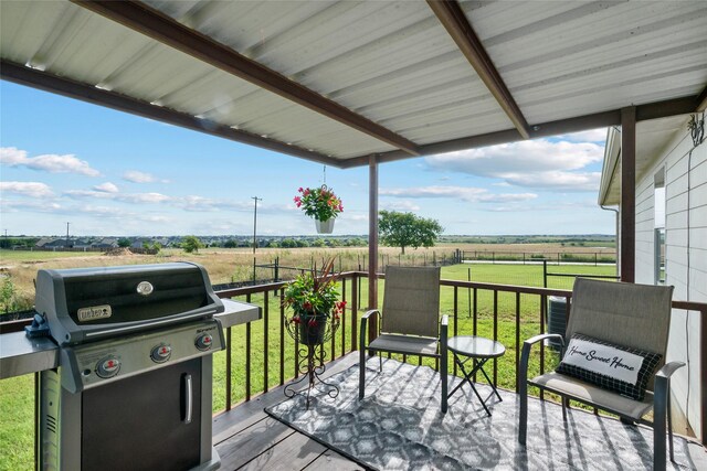 wooden deck featuring area for grilling, a rural view, and a yard