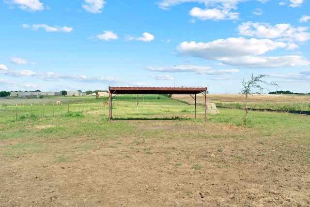 view of yard with a rural view and an outdoor structure