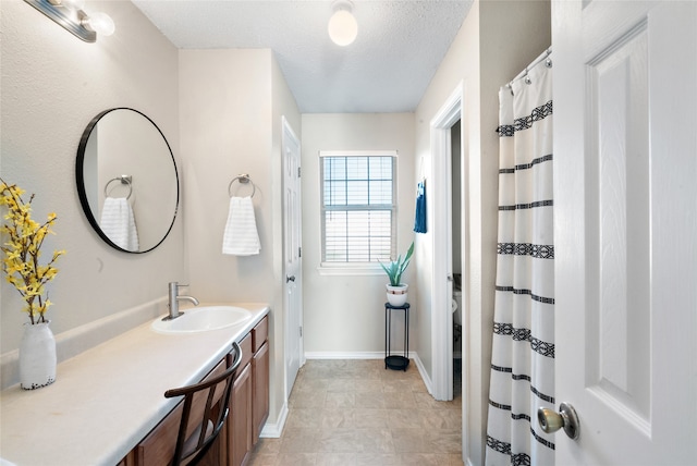 bathroom with vanity and a textured ceiling