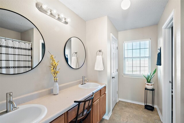 bathroom featuring a textured ceiling and vanity