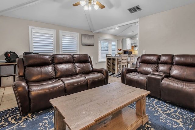 living room featuring ceiling fan, tile patterned flooring, and vaulted ceiling with beams