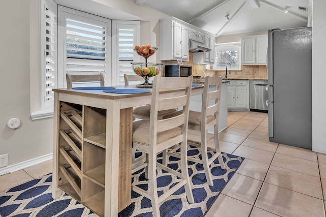 kitchen featuring light tile patterned flooring, sink, tasteful backsplash, stainless steel appliances, and white cabinets