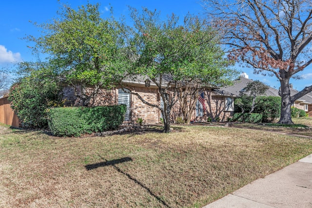 obstructed view of property with a front lawn