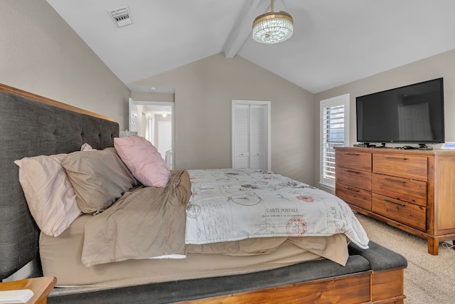 bedroom with a closet, lofted ceiling with beams, and carpet