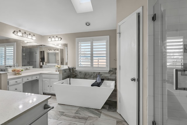 bathroom featuring separate shower and tub, vanity, a skylight, and tile walls