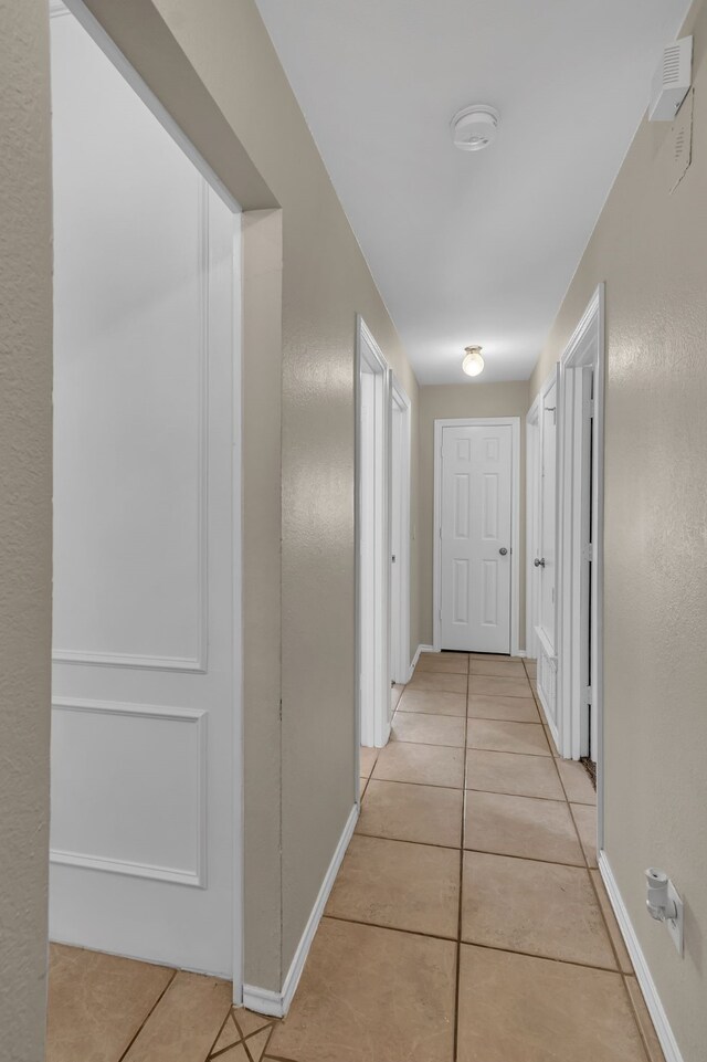 hallway featuring light tile patterned floors