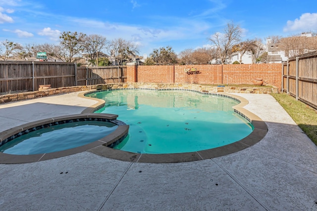 view of swimming pool featuring a patio and an in ground hot tub