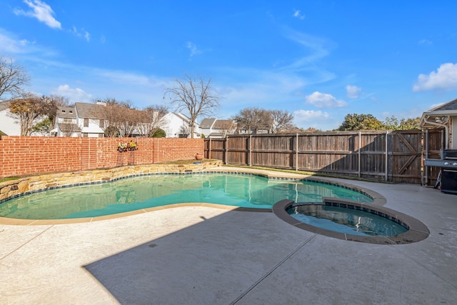 view of swimming pool with a patio and an in ground hot tub