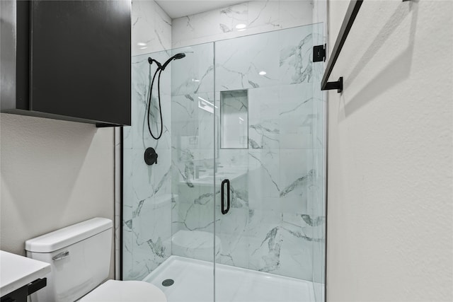 bathroom with vanity, an enclosed shower, and toilet