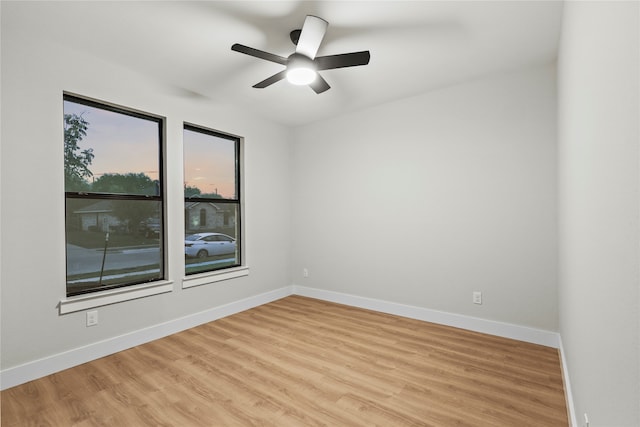 empty room featuring ceiling fan and light hardwood / wood-style flooring