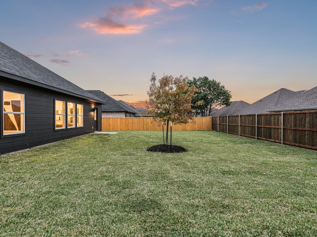 view of yard at dusk