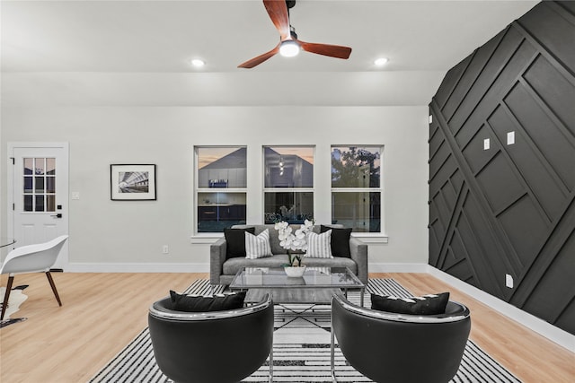 living room with hardwood / wood-style floors, vaulted ceiling, and ceiling fan