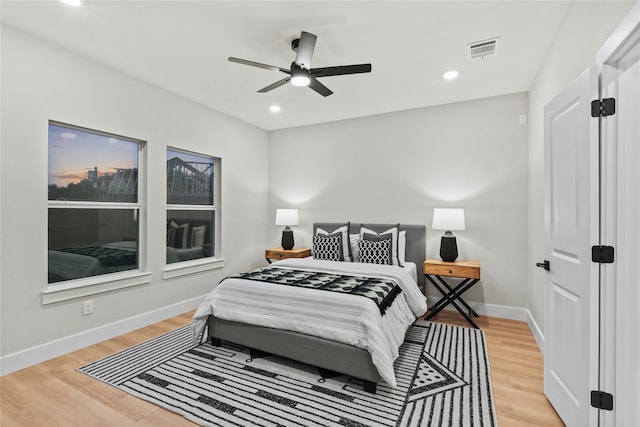 bedroom with light hardwood / wood-style flooring and ceiling fan