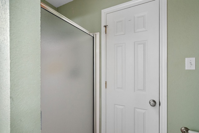 bathroom with a shower with shower door