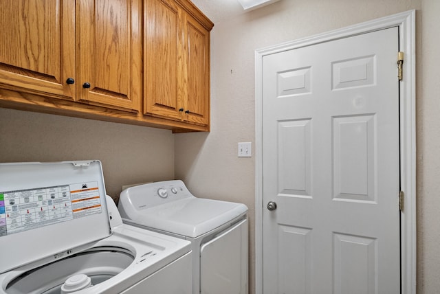 clothes washing area with cabinets and independent washer and dryer