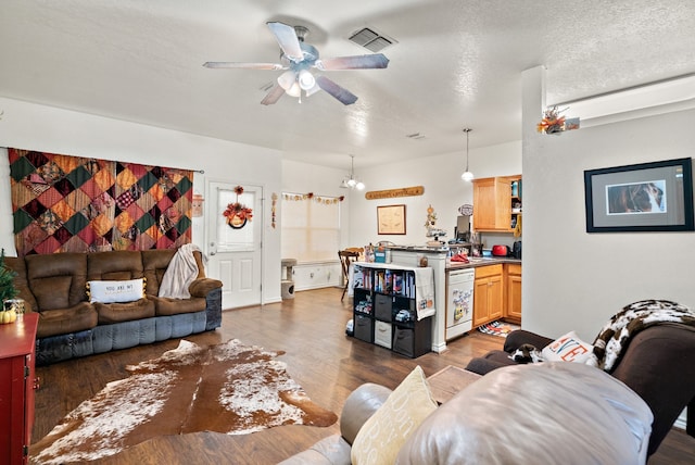 living room with a textured ceiling, ceiling fan with notable chandelier, and dark hardwood / wood-style floors