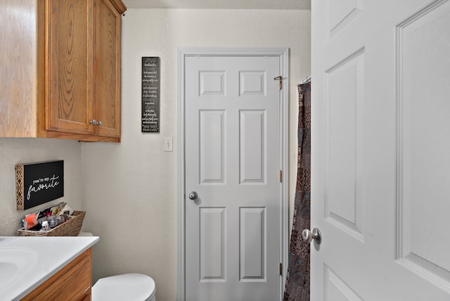 bathroom featuring vanity and toilet