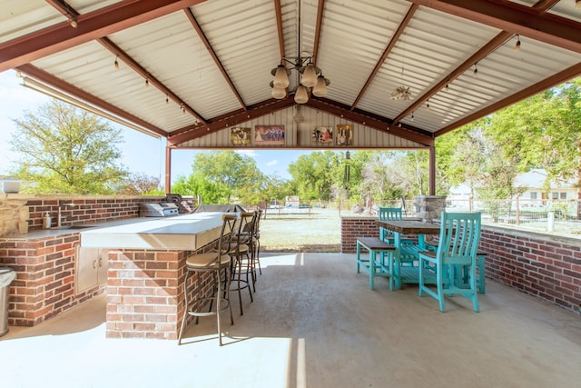 view of patio / terrace with a gazebo, area for grilling, and a bar