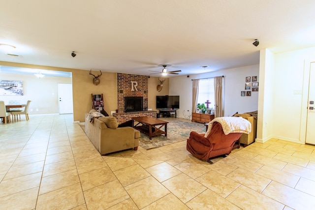 tiled living room with a fireplace and ceiling fan