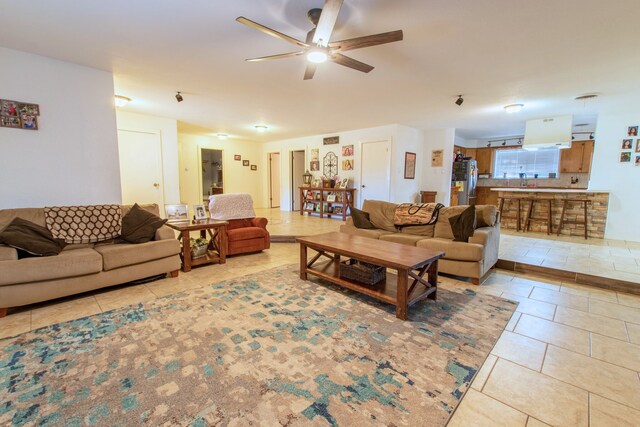 living room with ceiling fan and light tile patterned floors