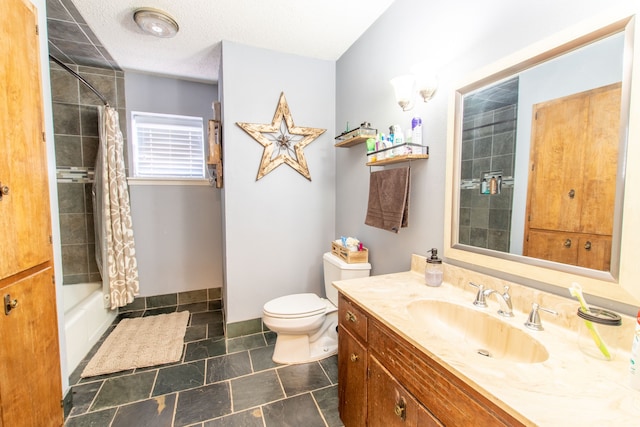 full bathroom with shower / bath combo with shower curtain, vanity, a textured ceiling, and toilet