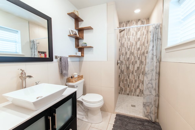 bathroom featuring a shower with curtain, toilet, tile walls, and vanity