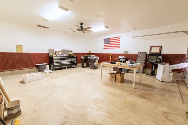 miscellaneous room with ceiling fan and concrete flooring