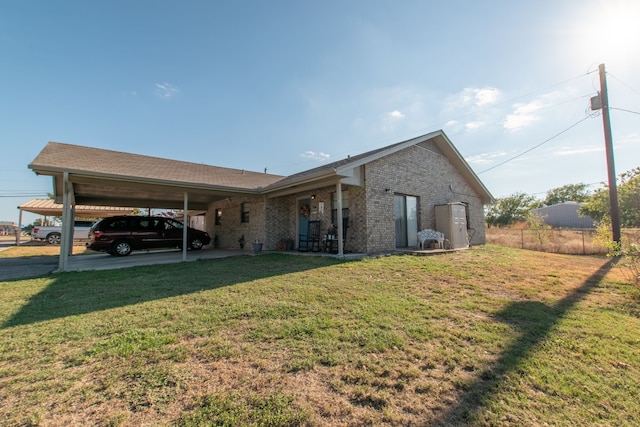 ranch-style home with a carport and a front lawn