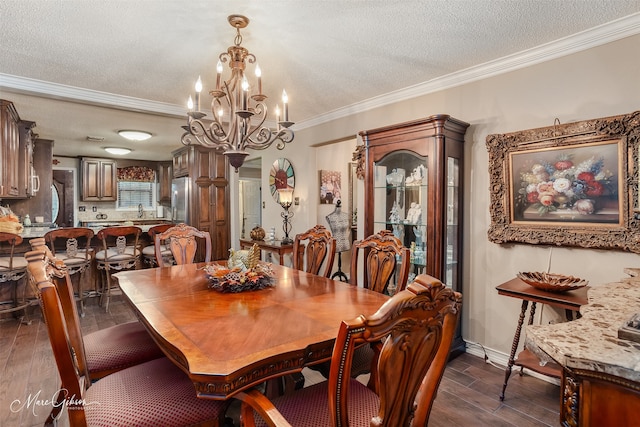 dining space featuring dark hardwood / wood-style flooring, a chandelier, a textured ceiling, and ornamental molding