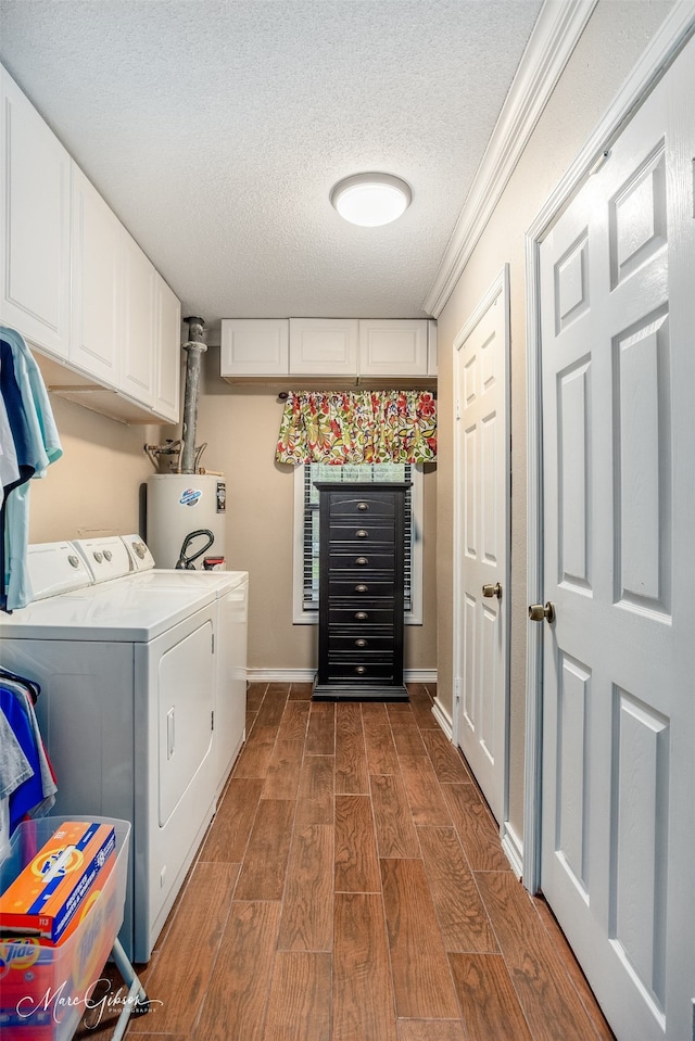 laundry area with ornamental molding, a textured ceiling, water heater, washing machine and dryer, and dark hardwood / wood-style floors