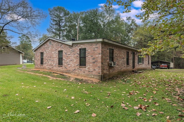 view of side of property featuring a yard, a carport, and cooling unit