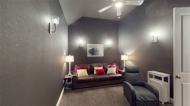 carpeted cinema room with vaulted ceiling and ceiling fan