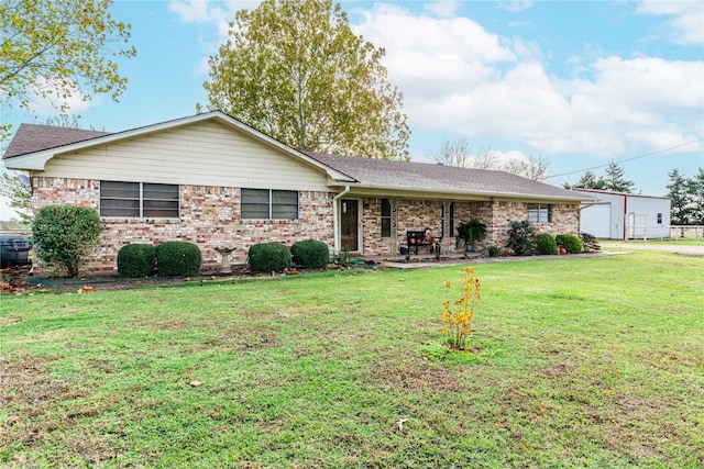 single story home with a garage and a front lawn