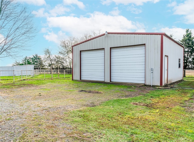 garage featuring a lawn