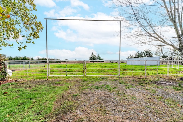 view of yard featuring an outdoor structure and a rural view