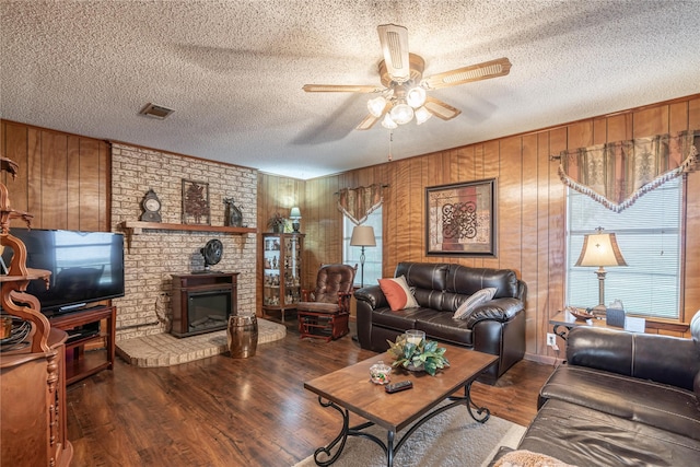 living room featuring a healthy amount of sunlight, hardwood / wood-style floors, and ceiling fan