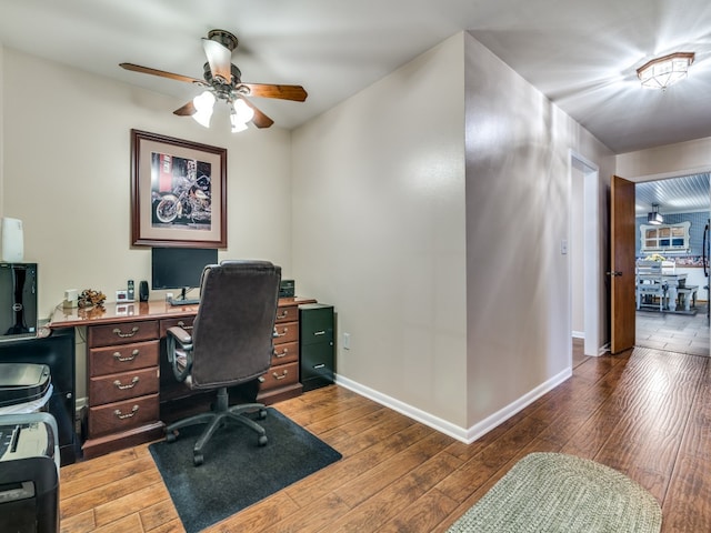 home office featuring hardwood / wood-style floors and ceiling fan