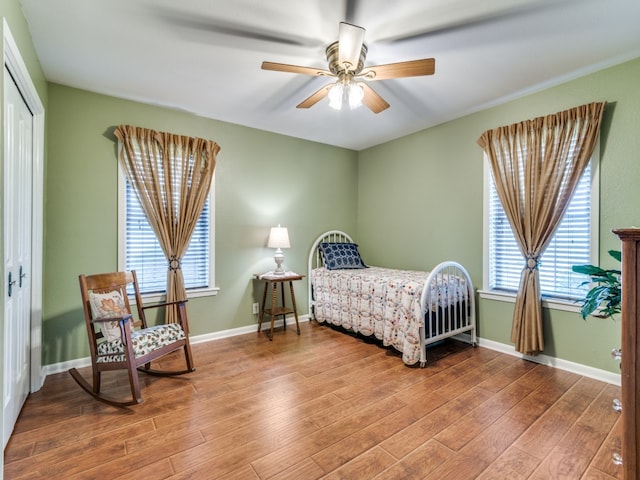 bedroom featuring hardwood / wood-style floors, a closet, and ceiling fan